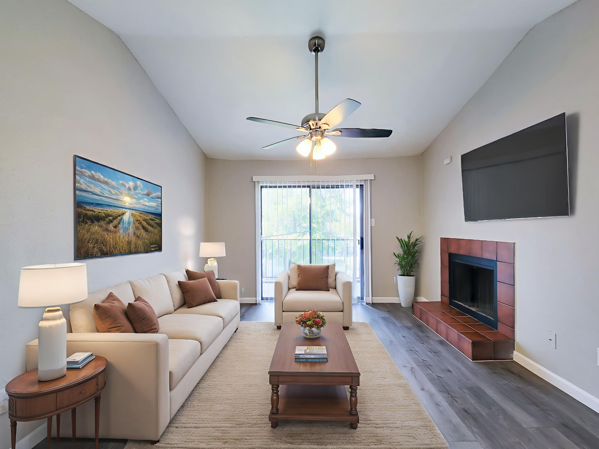 Living room with vaulted ceiling, tile fireplace and patio doors