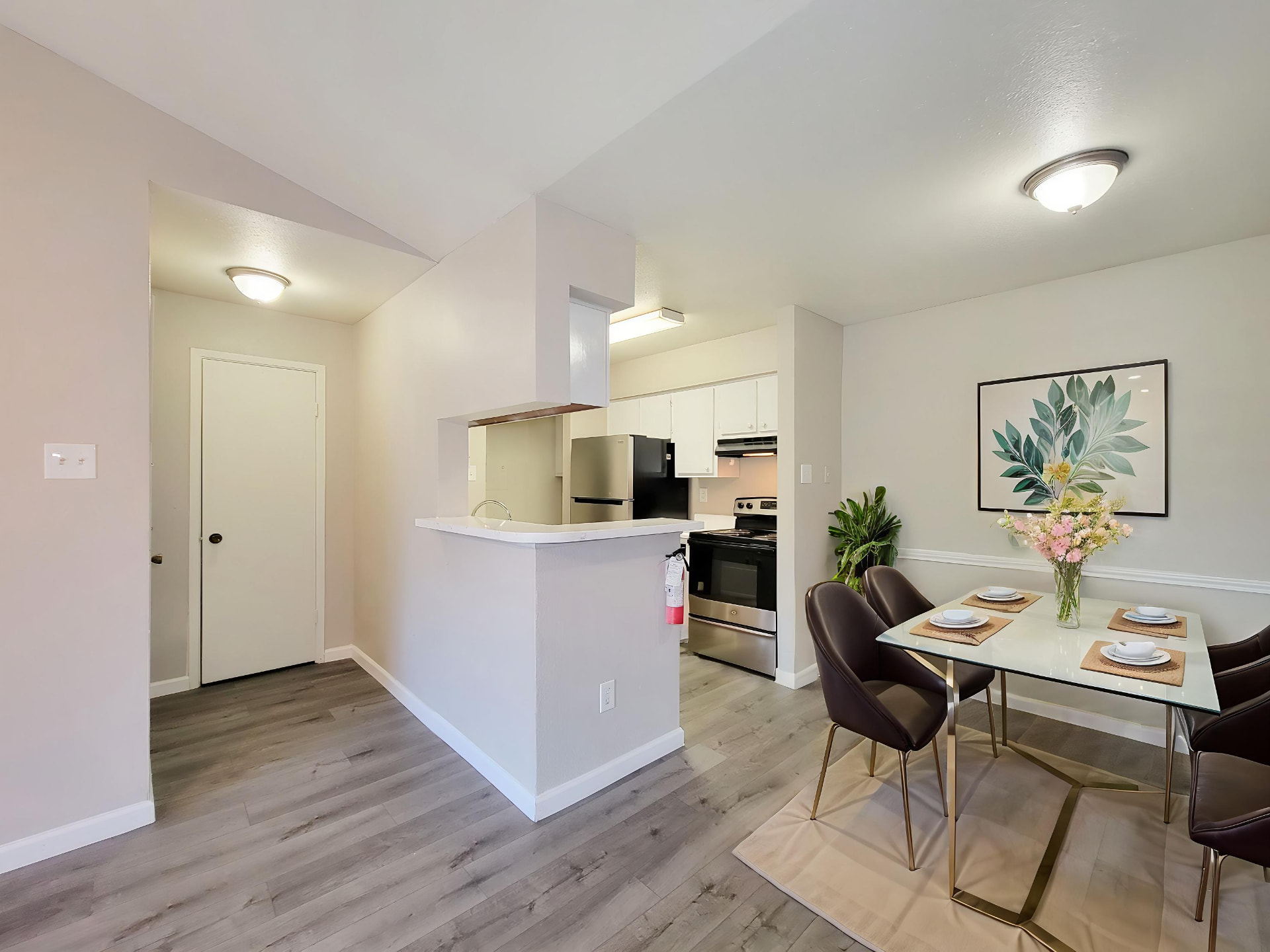 Open kitchen and dining area with breakfast bar and wood-style flooring